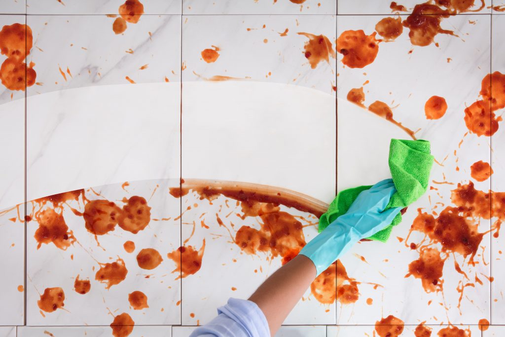 A person wiping away food stains​